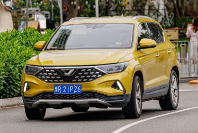 Bold diamond-pattern grille and angular LED daytime running lights on a yellow SUV.