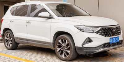 Front side view of an SUV with alloy wheels and sharp headlights