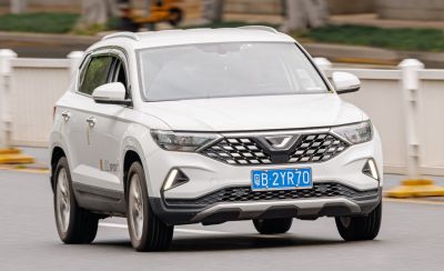 Front of white SUV with diamond-pattern grille and LED fog lights