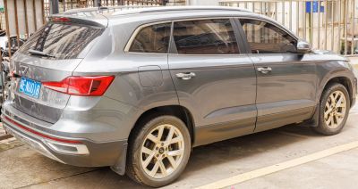Rear side view of a mid-size SUV with distinctive tail lights and alloy wheels