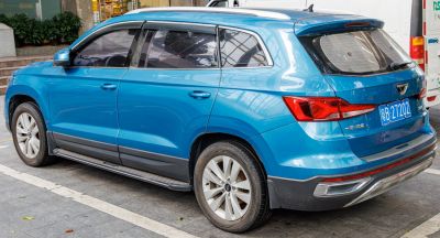 Rear side view of blue SUV with modern taillights and alloy wheels