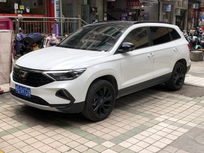 White SUV with black rims and modern grille design