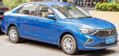 Blue sedan front side view with grille and headlights.