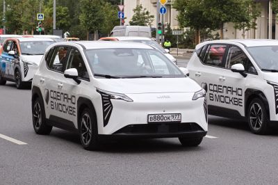 Electric vehicle with unique vertical LED headlights and compact modern design.