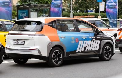Multicolor electric hatchback with modern rims and urban street background
