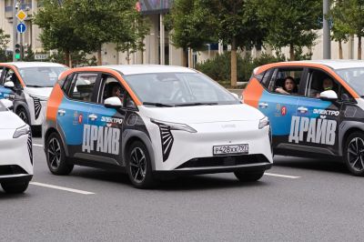 Front and side views of a compact electric vehicle with distinctive lights and side graphics