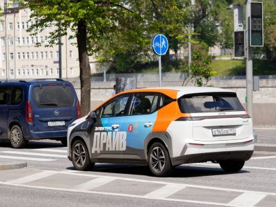 Rear-side view of electric hatchback with colorful design and unified rear light strip.