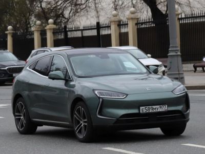 Sleek modern electric SUV with front view showing slim headlights and aerodynamic design