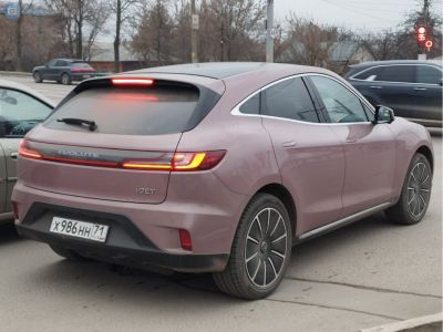 Rear view of sleek electric SUV with modern taillights and aerodynamic design