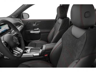 Black car seats with red stitching and modern dashboard