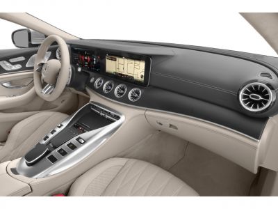 Luxury modern car interior with dual digital screens and elegant air vents.