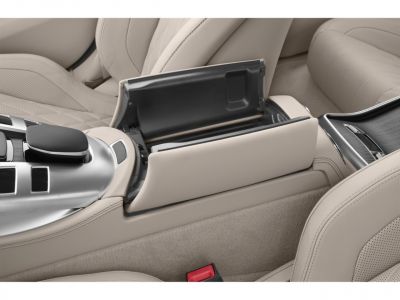 Beige leather center console storage with modern car controls
