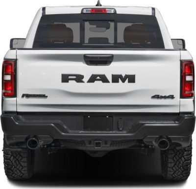 Rear view of pickup with Rebel and 4x4 badges, dual exhaust, and rugged tires
