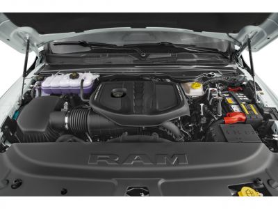 Twin turbo engine under lifted hood with detailed engine bay components.