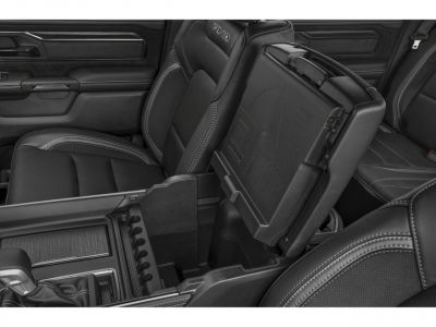 Interior storage compartment with black leather seats and center console.