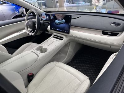 White modern car interior with large central touchscreen and minimalist design