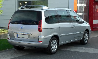 Rear angle of silver minivan with vertical taillights and roof rails