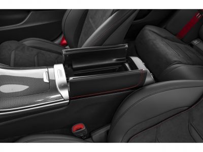 Center console storage and carbon fiber trim with red stitching in car interior