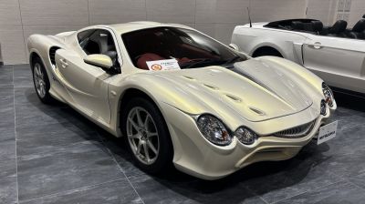 Sporty coupe with unique hood vents and quad round headlights