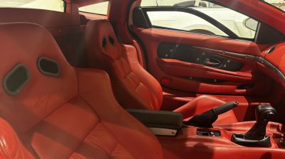 Red leather racing-style seats and manual gearshift interior