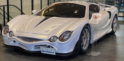 Front view with distinctive multi-lens headlights and aerodynamic hood design