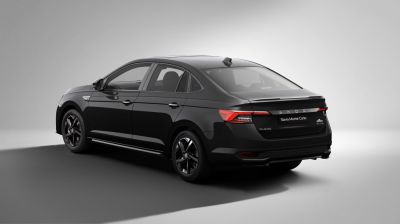 Rear-side view of black sedan with alloy wheels and tinted windows