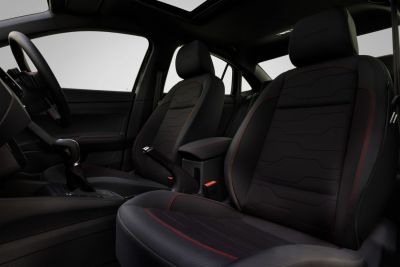Sporty black seats with red stitching and ergonomic design in modern car interior