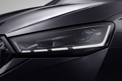 Close-up of sleek LED headlight with projector and daytime running lights
