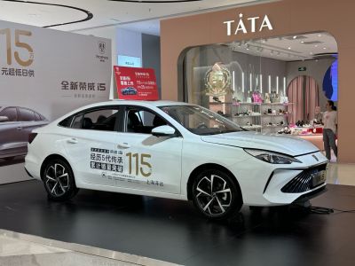 Sharp front grille and modern alloy wheels on a white sedan