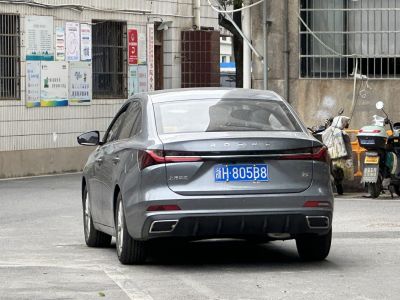 Rear view of sedan with sleek LED tail lights and dual exhaust outlets.