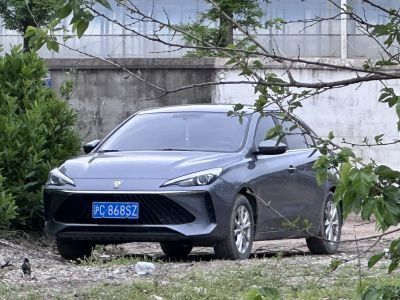 Front view of a modern sedan with sharp headlights and large trapezoidal grille