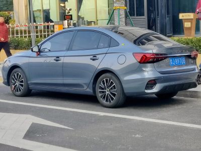 Rear side view of a sedan with tinted windows and alloy wheels