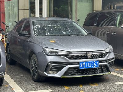 Front view with sharp headlights and distinctive grille of a sedan.