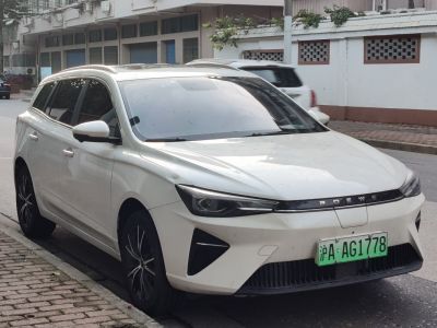 White electric wagon front with sleek headlights and roof rails