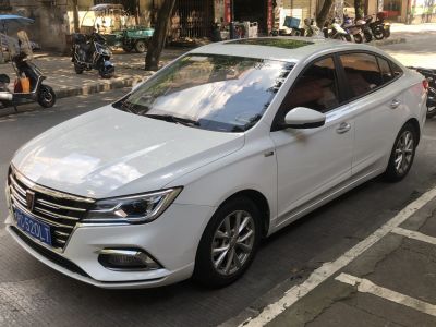 White mid-size sedan front-side view with sleek headlights and chrome grille