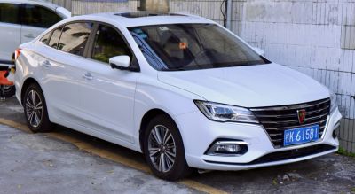 Front-side view of a white sedan with angular headlights and prominent grille