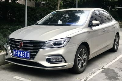 Modern sedan front view with LED headlights and alloy wheels