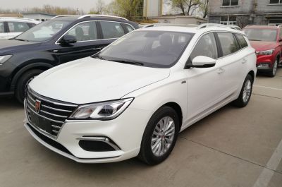 White estate vehicle front-side view with grille and alloy wheels