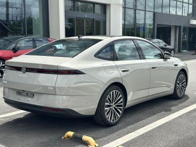 Rear and side profile of electric sedan with sleek design and alloy wheels
