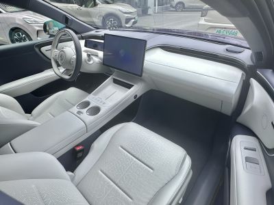 Modern car interior with digital dashboard and large touchscreen.