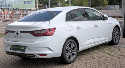 White sedan rear and side view with sleek taillights and alloy wheels
