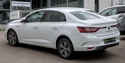 Rear and side view of a white modern sedan with sculpted body and distinctive taillights