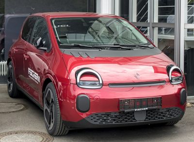 Front angle of a red compact urban hatchback with circular LED headlights