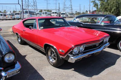 Front view with dual headlights, SS grill, and red sport coupe body