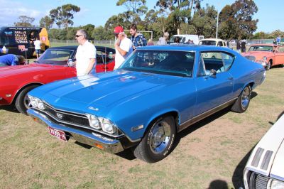 Blue vintage muscle sport coupe with quad headlights and chrome bumper