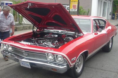 Open engine bay of classic muscle car with chrome and air filter