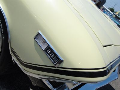 Close-up of muscle car hood with 396 emblem and racing stripes