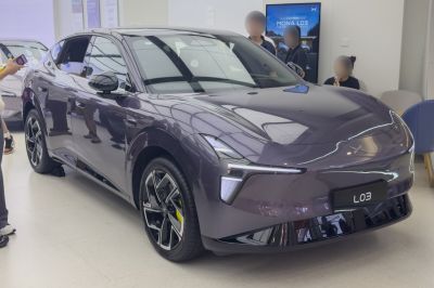Sleek electric sedan with angular LED headlights and sporty alloy wheels