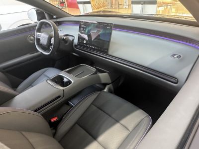 Modern car interior with large touchscreen dashboard and ambient lighting