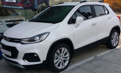 White compact SUV front-side view with alloy wheels, sleek headlights.